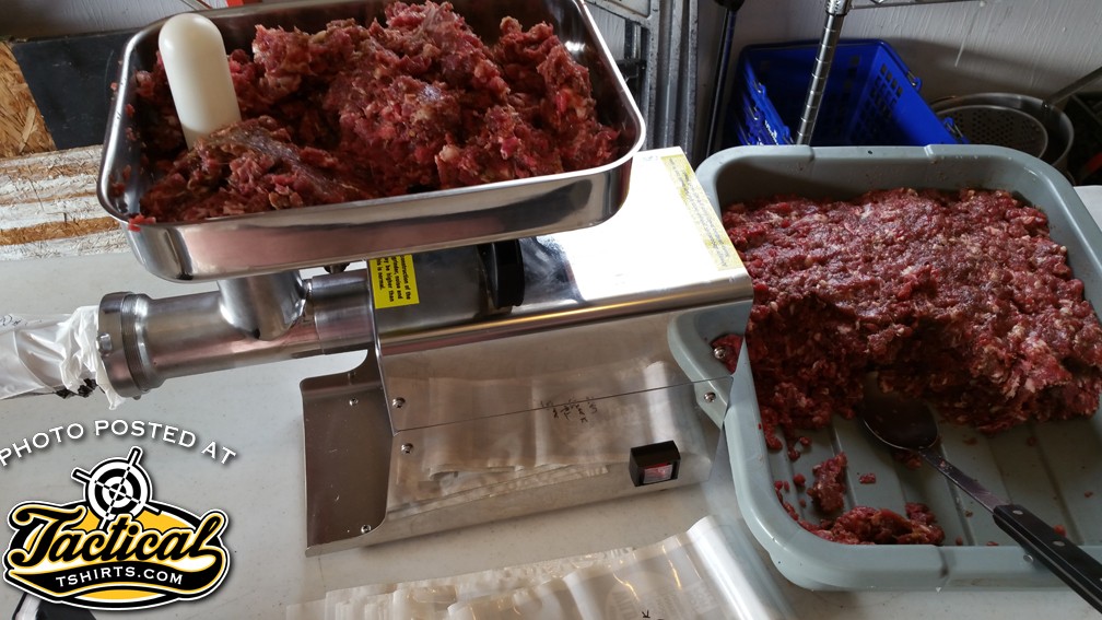 Meat on the table in the grinder. 